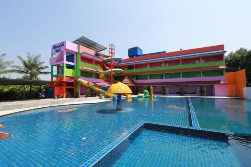 a pool with a water slide in front of a building at Chiang Rai Park Resort in Chiang Rai