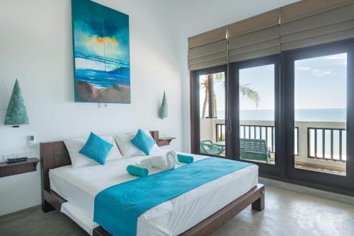 una camera con letto e vista sull'oceano di At Ease Beach Hotel a Hikkaduwa