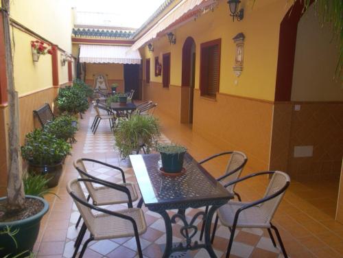 a patio with tables and chairs in a building at Hostal Monteolivos in Cártama