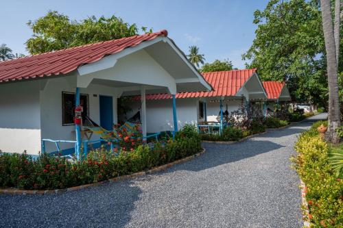 a row of houses with red roofs at Isara Lanta Beach Resort in Ko Lanta