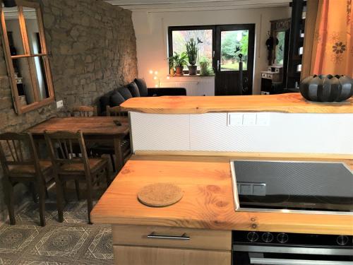 a kitchen with a counter and a dining room with a table at Haus Rothenberg in Nohfelden