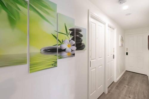 a hallway with three paintings on the wall at Comfy Private Single Room in Carramar - Nearby Station & Shops - Shared Bathroom in Sydney