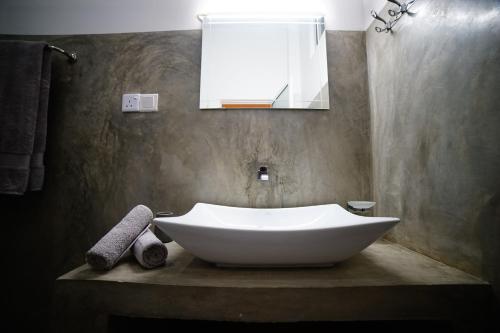 a white tub in a bathroom with a sink at Island life in Negombo