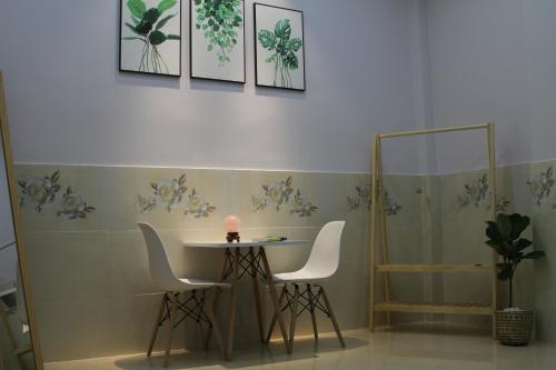 a room with a table and two chairs and a table at Nature House Homestay in Ho Chi Minh City