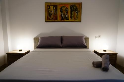 a bedroom with a bed with two nightstands and two tables at Island life in Negombo