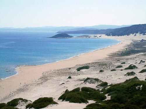 a view of a beach next to the ocean at Penthouse With Breathtaking Panoramic Views of Mediterranean sea and Mountain in Akanthou