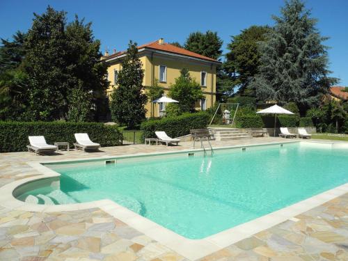 a swimming pool in front of a house at Villa Verganti Veronesi in Inveruno