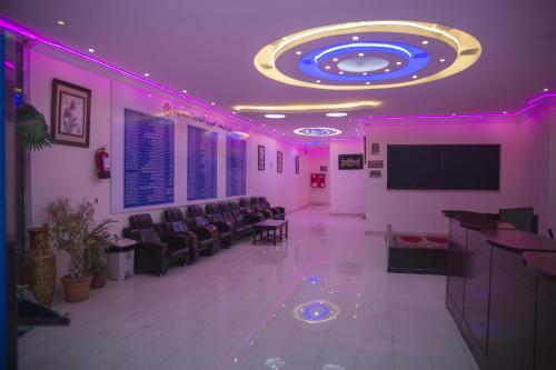 a waiting room with chairs and a flat screen tv at Al Eairy Apartment-Alqaseem 4 in Buraydah