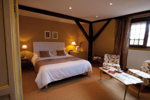 - une chambre avec un lit, une table et une chaise dans l'établissement Le Gouverneur Hotel, à Obernai
