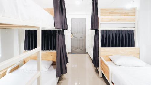a bedroom with two bunk beds in a house at Loyy Hotel in Chiang Mai