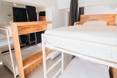 a dorm room with two bunk beds in it at Loyy Hotel in Chiang Mai