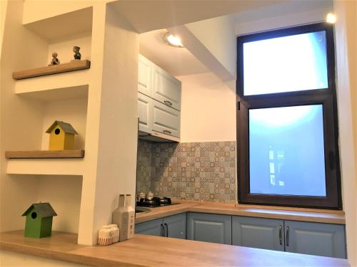 a kitchen with a large window in a kitchen at White Wolf Apartment in Braşov