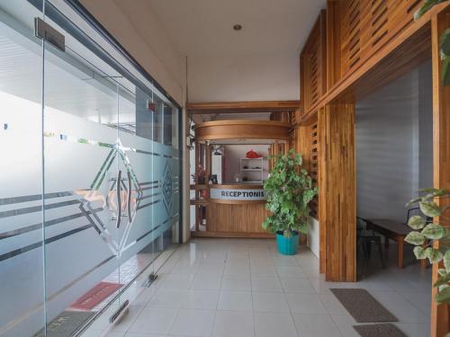 a hallway of a house with a table and a plant at RedDoorz near Gajah Mada Pontianak in Pontianak