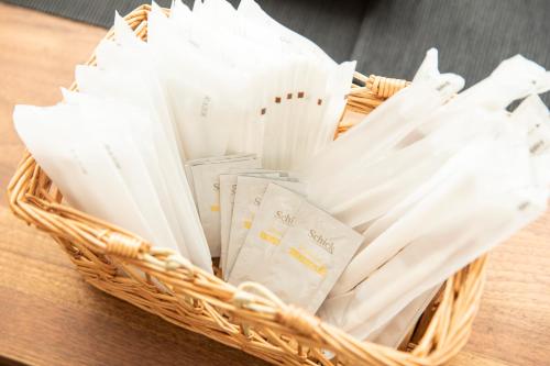 a basket filled with white folded books on a table at RIVER VILLAS HIROSHIMA in Hiroshima