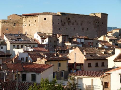 a group of buildings with a castle in the background at Casa rural Villanueva in Mora de Rubielos