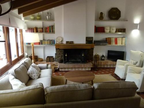 a living room with a couch and a fireplace at Casa rural Villanueva in Mora de Rubielos