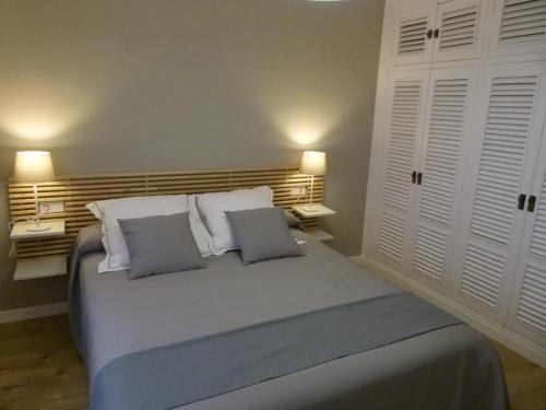 a bedroom with a large bed with two pillows at Casa rural Villanueva in Mora de Rubielos