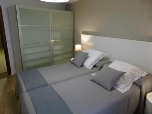 a bedroom with a large bed with two pillows at Casa rural Villanueva in Mora de Rubielos