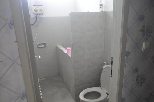 a small bathroom with a toilet and a shower at Dallil Putra Villa in Lembang