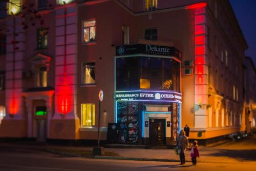 a man and a child walking in front of a building at Boutique Hotel Renaissance in Murmansk