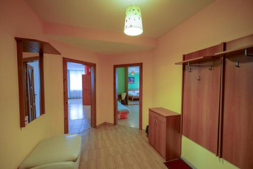 a room with a hallway with a chair and a table at Penzion Fantazia Poprad - Self check-in in Poprad