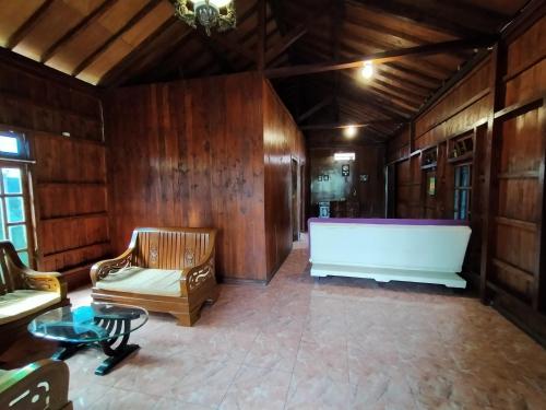 a living room with a large white bath tub at Jati Classic Homestay in Banyuwangi