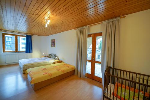 a bedroom with two beds and a window at Penzion Fantazia Poprad - Self check-in in Poprad