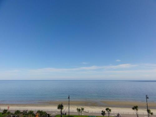 a view of the beach and ocean from a building at Edelweiss Guest House in Douglas