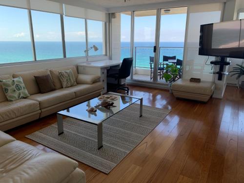 a living room with a couch and a table at The Penthouses Apartments in Gold Coast