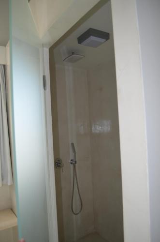 a shower in a bathroom with a glass door at Faros Resort in Azolimnos