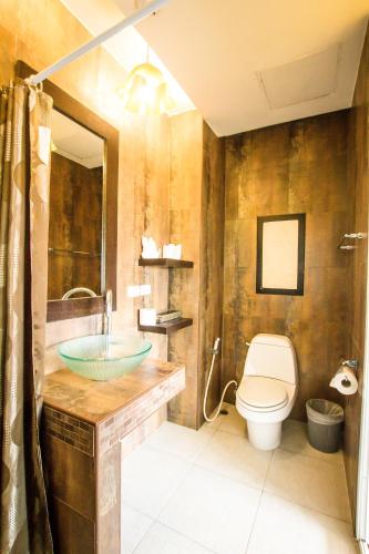 a bathroom with a sink and a toilet at Queen Boutique Hotel Chaweng in Chaweng