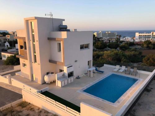 a villa with a swimming pool on top of a building at Villa Chrystalleni in Protaras