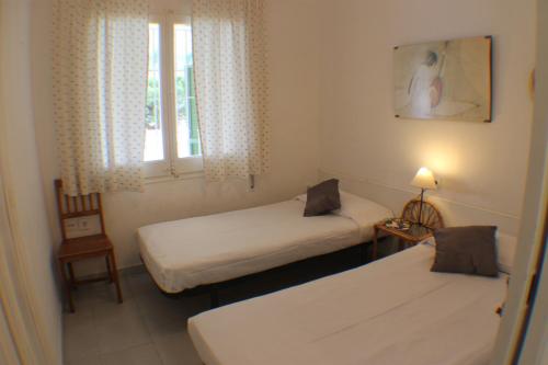 a small room with two beds and a window at Agi Casa Puerto in Roses