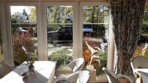 a dining room with a table and a large window at Hotel Rosengarten Leipzig-Naunhof in Naunhof
