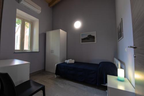 a bedroom with a bed and a desk and a window at "Il Segreto" Vista Panoramica sulle Isole Eolie con Piscina, palestra e WiFi in Patti
