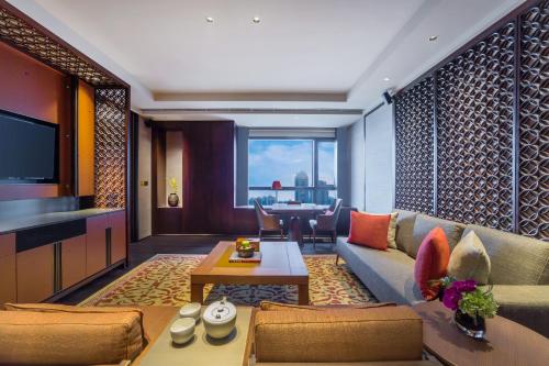 a living room with a couch and a table at Regent Chongqing in Chongqing