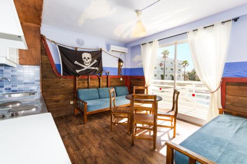 a living room filled with furniture and a window at Pirates Village in Santa Ponsa