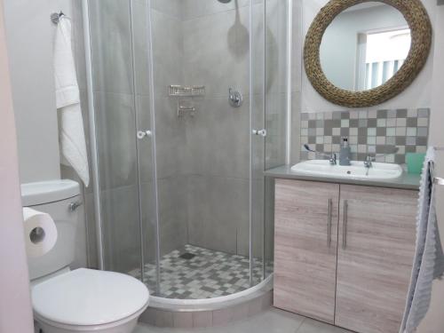 a bathroom with a shower with a toilet and a sink at Cul de Sac - Accommodation in George
