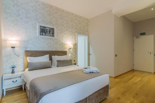 a bedroom with a large bed in a room at New Era Hotel Old Town Bucharest- parking with fee nearby - NOT at the hotel ! in Bucharest