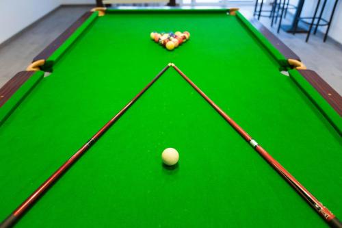 a green snooker table with balls on it at Lagoonie Lodge & Beach in Hurghada