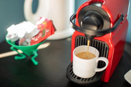 a coffee maker is making a cup of coffee at Villa Nestor in Ingenio
