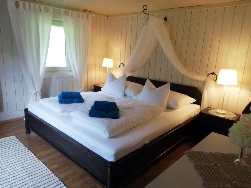 a bedroom with a bed with two blue pillows on it at Almliesl MAIS-590 in Maishofen