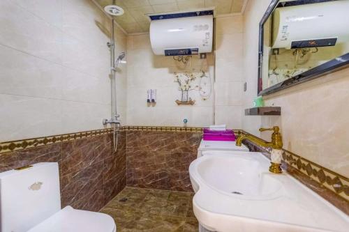 a bathroom with a toilet and a sink at Utopia Apartment in Harbin