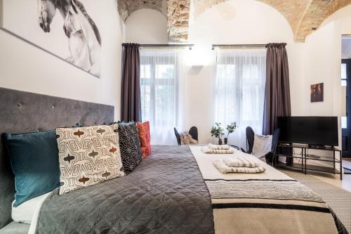 a bedroom with a large bed with pillows on it at Urban Stable Luxury Apartments in Budapest
