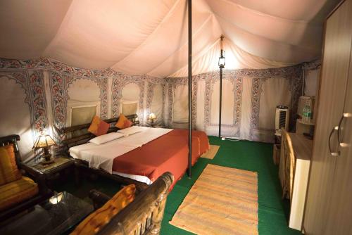 a bedroom with a bed in a tent at Zizina Otis Resort in Guwahati
