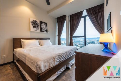 a bedroom with a bed and a large window at KLCC View Expressionz Family Loft by WGS in Kuala Lumpur