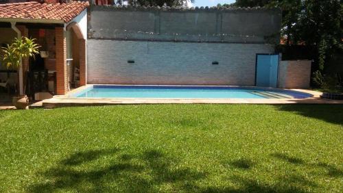 a swimming pool in the yard of a house at Beulah Hotel Boutique in Asunción