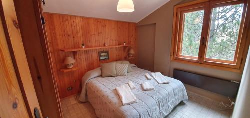 a bedroom with a bed with towels on it at SNOW HOUSE in Rivisondoli