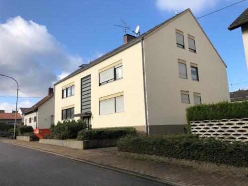 a white building on a street at Saarland Appartements in Wadgassen