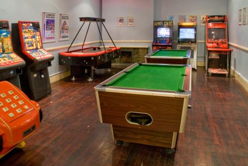 a room with several arcade games and pool tables at Norbreck Castle Hotel & Spa in Blackpool
